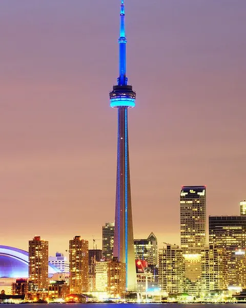 The CN Tower and Toronto skyline lit up at dusk
